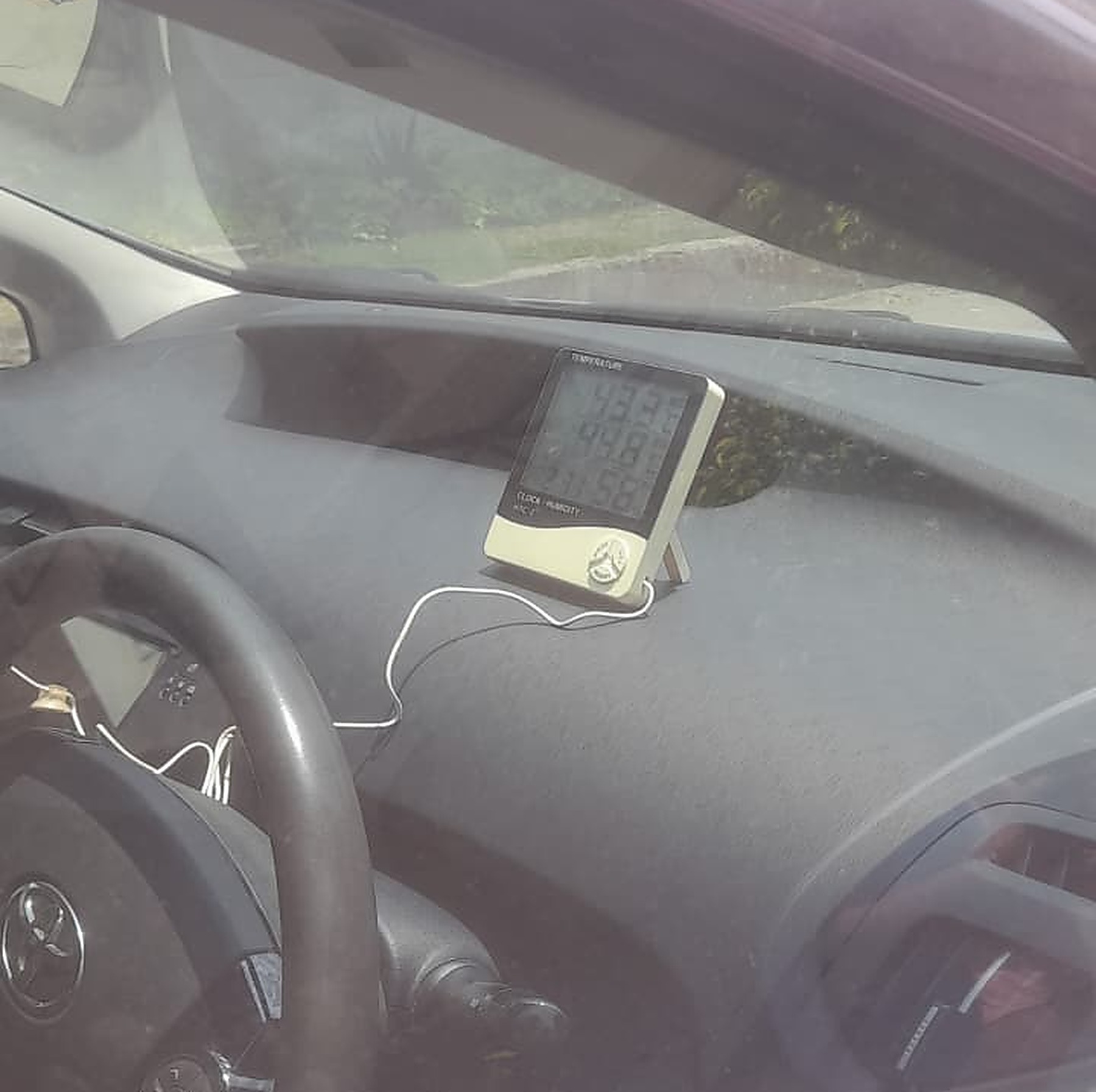 Before UV tint β Toyota Prius dashboard, untinted glass, meter showing 44Β°C cabin